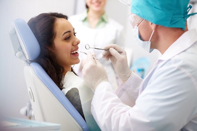 A happy dental patient receives care.