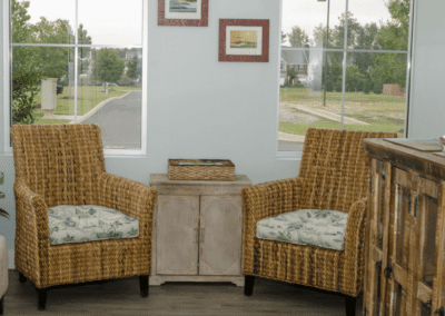 Wicker chairs with big, soft cushions sit ready for patients to enjoy when they come in to visit the endodontist office.