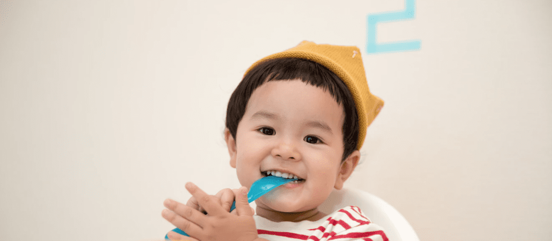 A small child eats soft food after a root canal.