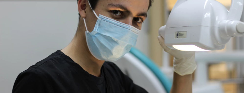 An endodontist looks at the camera before performing a root canal.